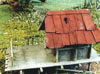 Building with a corrugated iron roof and gun platform - note hole in roof