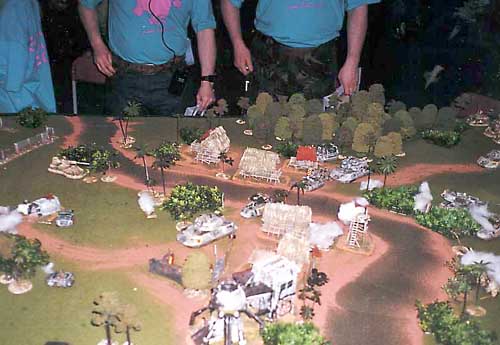 A Slammers column negotiate a river defended by various units including a Tank Destroyer at the Rolling Hot game at Salute 2000