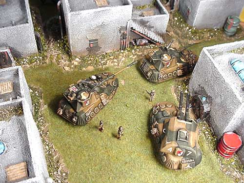 Jaeger Tank Killers and Vulcan AAA advance through a town square with Thunderbolt Division Infantry in support