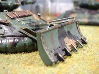the Crusader mounts an effective dozer blade at the front of the vehicle. This also adds to frontal armour