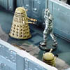 A cyberman is cornered and attacked by Imperial Daleks